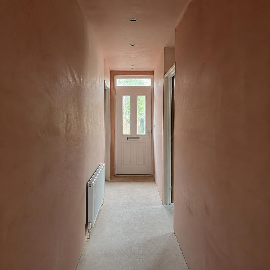 Newly plastered hallway leading to the front door